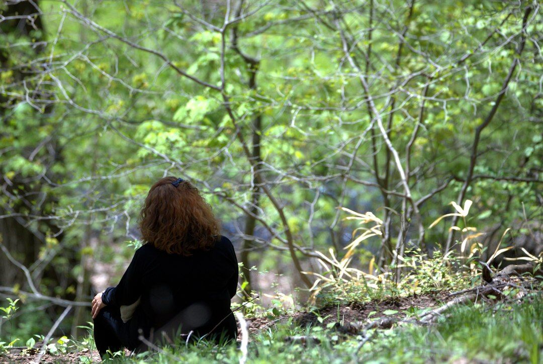 person meditating in nature
